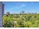 Expansive city view with lush green trees and neighborhood buildings under clear blue skies at 2575 Peachtree Ne Rd # 15G, Atlanta, GA 30305