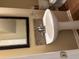 Stylish half bath with a pedestal sink, modern mirror, and patterned tile accent at 1629 Marsanne Ter, Kennesaw, GA 30152