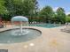 Community pool with water feature, sunbathing deck, and lounge chairs perfect for outdoor relaxation at 1629 Marsanne Ter, Kennesaw, GA 30152