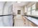 Galley kitchen with stainless steel appliances and white tile flooring at 3221 Colquitt Dr, Atlanta, GA 30340