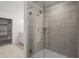 Modern bathroom shower with gray tiled walls and frameless glass door at 3382 Monarch Ave, Duluth, GA 30096