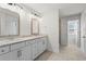 Bright bathroom featuring double vanity with stone countertop and neutral color palette at 3382 Monarch Ave, Duluth, GA 30096