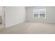 Spacious bedroom with ample natural light and a view to the ensuite bathroom at 3382 Monarch Ave, Duluth, GA 30096