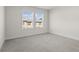 Large bedroom with plush neutral carpet and sunny view from dual windows at 3382 Monarch Ave, Duluth, GA 30096