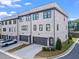 Beautiful new construction townhouse exterior with brick facade, a private garage, and manicured landscaping at 3382 Monarch Ave, Duluth, GA 30096