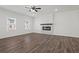 Well-lit living room featuring hardwood floors, modern windows, and a fireplace creating a welcoming space at 3382 Monarch Ave, Duluth, GA 30096