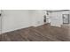 Open concept living area showcasing a kitchen with white cabinets and stainless steel appliances at 3382 Monarch Ave, Duluth, GA 30096