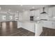 This open-concept living area flows seamlessly into the kitchen with a white island and stainless steel appliances at 3382 Monarch Ave, Duluth, GA 30096