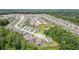 A sprawling neighborhood unfolds in this aerial view, set amidst lush greenery and mature trees at 3392 Fall Branch Ln, Buford, GA 30519