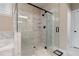 Elegant bathroom featuring a glass shower with marble tile, shower seat and black hardware at 3392 Fall Branch Ln, Buford, GA 30519