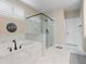 Elegant bathroom featuring a soaking tub, frameless glass shower, and stylish marble-look tile at 3392 Fall Branch Ln, Buford, GA 30519
