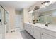 Luxurious bathroom with a double vanity, glass-enclosed shower, and a soaking tub at 3392 Fall Branch Ln, Buford, GA 30519
