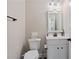Compact half bathroom featuring modern fixtures, a vanity with storage, and neutral decor at 3392 Fall Branch Ln, Buford, GA 30519