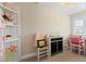Bright bedroom with a built-in shelf, desk, black cabinet, and decorative pink accents at 3392 Fall Branch Ln, Buford, GA 30519