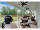 Inviting covered patio with ceiling fans, a grill, and outdoor furniture, perfect for entertaining at 3392 Fall Branch Ln, Buford, GA 30519