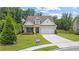 Charming brick front exterior featuring a well-manicured lawn and an attached two-car garage at 3392 Fall Branch Ln, Buford, GA 30519