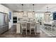 Open-concept kitchen showcasing granite countertops, stainless appliances, and bar stool seating at 3392 Fall Branch Ln, Buford, GA 30519