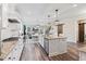 Bright kitchen with stainless steel appliances, a large island, and stylish lighting at 3392 Fall Branch Ln, Buford, GA 30519
