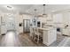 Bright kitchen featuring granite countertops, stainless steel appliances, and a central island with seating at 3392 Fall Branch Ln, Buford, GA 30519