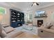 Comfortable living room with stone fireplace, built-in bookcase, and plenty of natural light at 3392 Fall Branch Ln, Buford, GA 30519