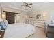 Comfortable main bedroom with tray ceilings, stylish furniture, and access to en-suite bathroom at 3392 Fall Branch Ln, Buford, GA 30519