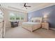 Serene main bedroom with tray ceilings, soft carpeting, and large windows for ample light at 3392 Fall Branch Ln, Buford, GA 30519