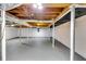 Unfinished basement shows white painted walls, support beams, and gray painted floors and support columns at 3122 Vandiver Dr, Marietta, GA 30066