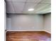 Unfinished basement offers wood-look flooring, freshly painted walls, and a drop ceiling with light at 3122 Vandiver Dr, Marietta, GA 30066