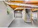 Unfinished basement offers stairs, exposed utilities, one window, and gray painted floors at 3122 Vandiver Dr, Marietta, GA 30066