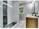 Bathroom features a glass-enclosed shower with modern black and white tile and vanity with double sinks at 3122 Vandiver Dr, Marietta, GA 30066