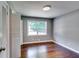 Bedroom featuring gleaming hardwood floors and a double door closet with a window providing natural light at 3122 Vandiver Dr, Marietta, GA 30066