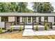 Close-up of a home's painted white brick exterior and dark trim with a well-manicured front porch at 3122 Vandiver Dr, Marietta, GA 30066