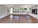 Bright living room featuring hardwood floors, a fireplace, white painted brick, and natural light from multiple windows at 3122 Vandiver Dr, Marietta, GA 30066