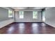Bright living room featuring hardwood floors, white painted brick, and natural light from multiple windows at 3122 Vandiver Dr, Marietta, GA 30066