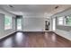 Living room showcasing hardwood floors, white painted brick, two entrances, and natural light from multiple windows at 3122 Vandiver Dr, Marietta, GA 30066