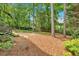 Large backyard with mature trees and wooden fence at 3473 Whisperwood Nw Ct, Marietta, GA 30064