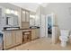 Bright bathroom featuring double sinks, granite counters, and tiled floors at 3473 Whisperwood Nw Ct, Marietta, GA 30064