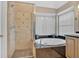 Well-lit bathroom featuring granite counters, tub, and glass shower at 3473 Whisperwood Nw Ct, Marietta, GA 30064