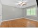 Empty bedroom with hardwood floors, ceiling fan, and window at 3473 Whisperwood Nw Ct, Marietta, GA 30064