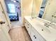 Clean secondary bathroom featuring double sinks, a large mirror, and a tile floor at 827 Autry Oak Ct, Johns Creek, GA 30022