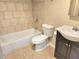 Tiled bathroom featuring a combined tub and shower, along with a modern vanity sink at 827 Autry Oak Ct, Johns Creek, GA 30022