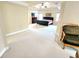 Large main bedroom with a tray ceiling, sitting area, and ample space at 827 Autry Oak Ct, Johns Creek, GA 30022