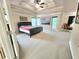 Spacious main bedroom featuring a tray ceiling, large windows, and access to the outdoors at 827 Autry Oak Ct, Johns Creek, GA 30022