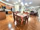 Dining area with wood floors and furniture adjacent to the kitchen and living room at 827 Autry Oak Ct, Johns Creek, GA 30022
