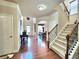 Inviting foyer featuring hardwood floors, an elegant staircase, and an open layout at 827 Autry Oak Ct, Johns Creek, GA 30022