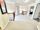 Bright hallway with neutral carpet, wood and iron railings, and doorways to other rooms at 827 Autry Oak Ct, Johns Creek, GA 30022
