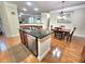 Lovely kitchen island with stainless steel dishwasher and hardwood floors overlooking the dining area at 827 Autry Oak Ct, Johns Creek, GA 30022
