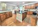 Lovely kitchen with island, stainless steel appliances, granite countertops, and wood floors at 827 Autry Oak Ct, Johns Creek, GA 30022