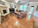 Bright living room features hardwood floors, a stone fireplace, and a door to the outside at 827 Autry Oak Ct, Johns Creek, GA 30022