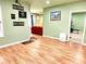 Comfortable living room with wood floors, sports decor and an adjacent exercise room at 827 Autry Oak Ct, Johns Creek, GA 30022